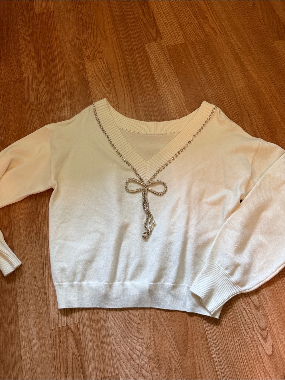 Cream Off-the-Shoulder V-Neck Sweater with Decorative Bow Accent
